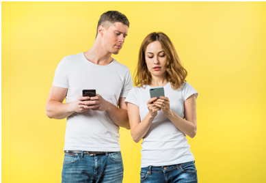 anxious-boyfriend-spying-his-girlfriend-texting-mobile-phone-against-yellow-backdrop_23-2148056079.jpg